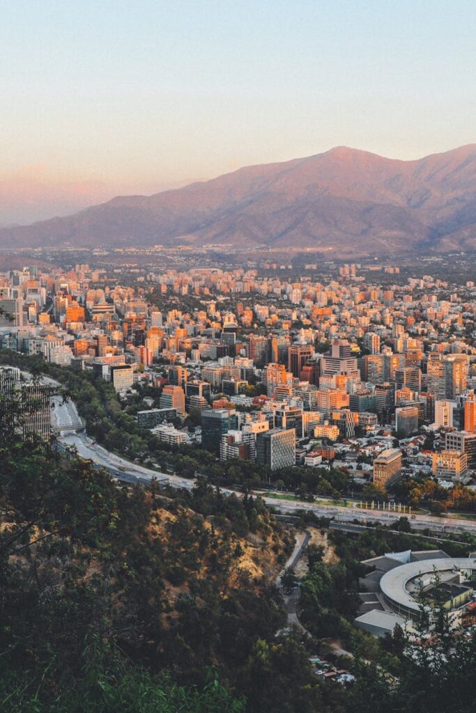 Breathtaking view of Santiago, Chile's skyline framed by mountains at sunset.